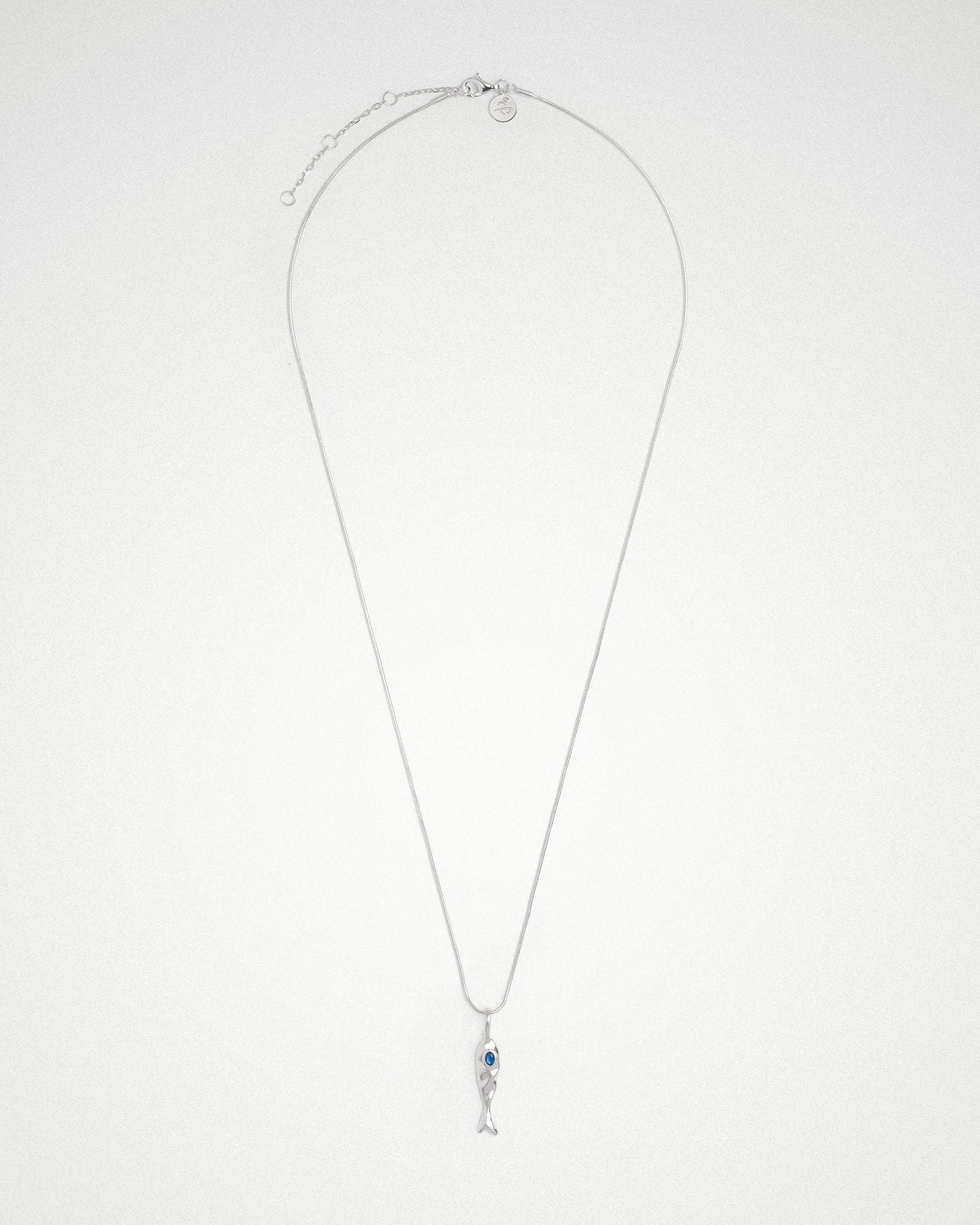 Molten 18k plated and rhodium silver fish-shaped pendant with blue sapphire on a round snake chain 