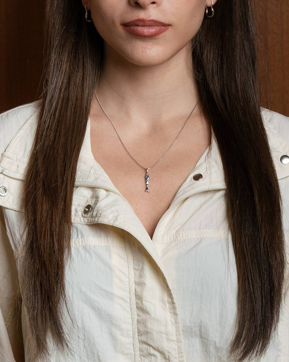 
Molten 18k plated and rhodium silver fish-shaped pendant with blue sapphire on a round snake chain 