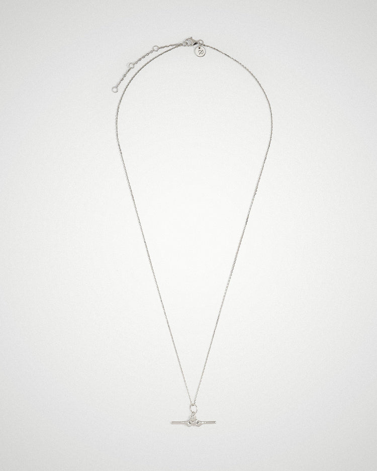 Close-up portrait wearing a sterling silver Claddagh bar necklace by Lines & Current