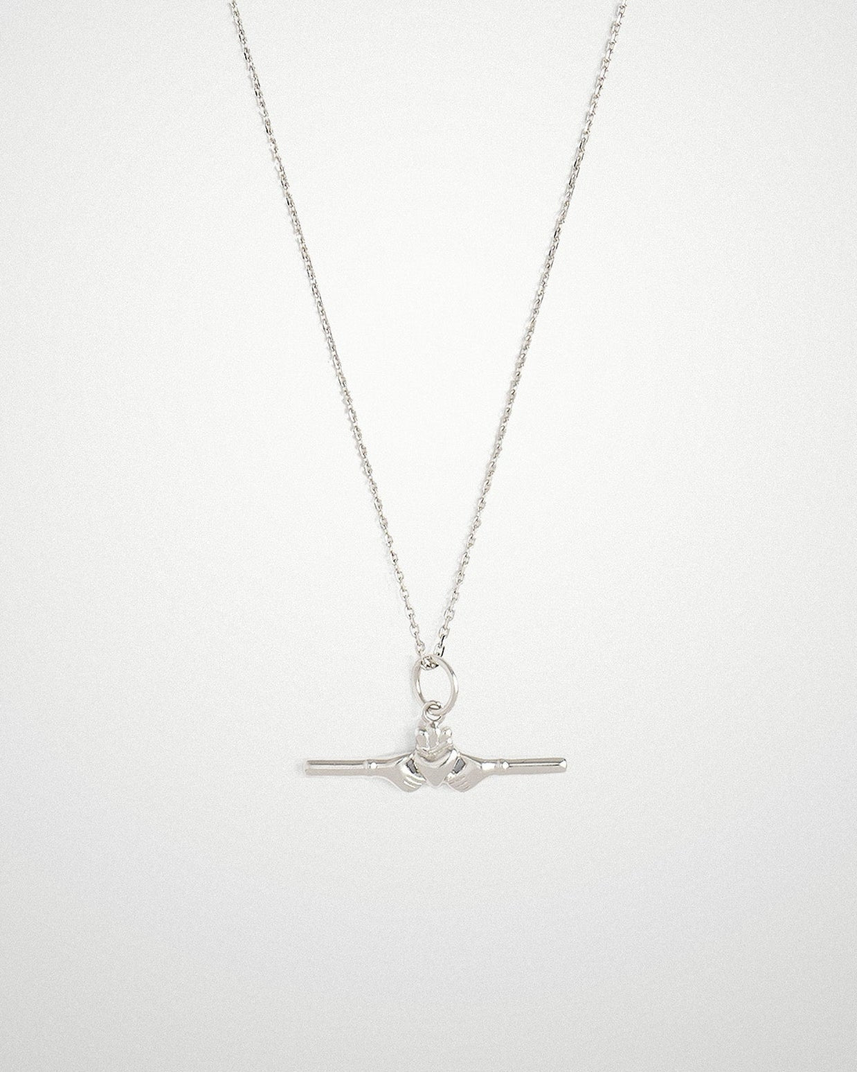 Sterling silver Claddagh bar necklace with a small horizontal bar pendant, on a light grey background