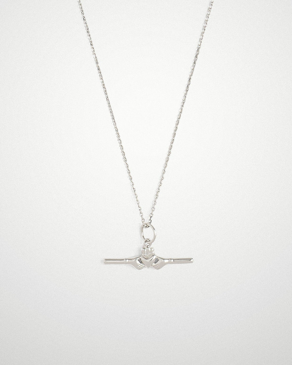 Sterling silver Claddagh bar necklace with a small horizontal bar pendant, on a light grey background