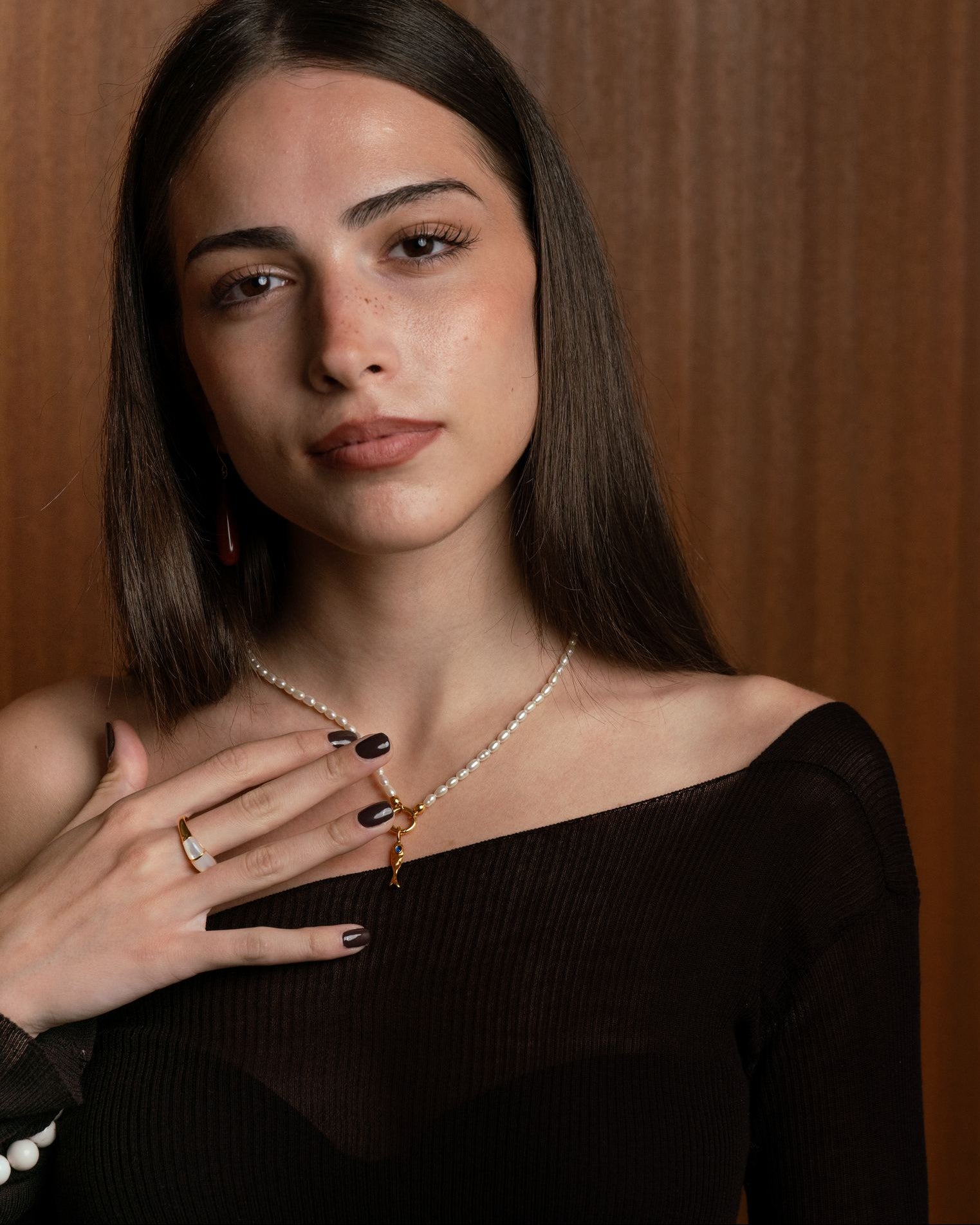 Mother of pearl charm holding necklace with central charm holder in 18k gold plating or rhodium plated silver with molten fish charm