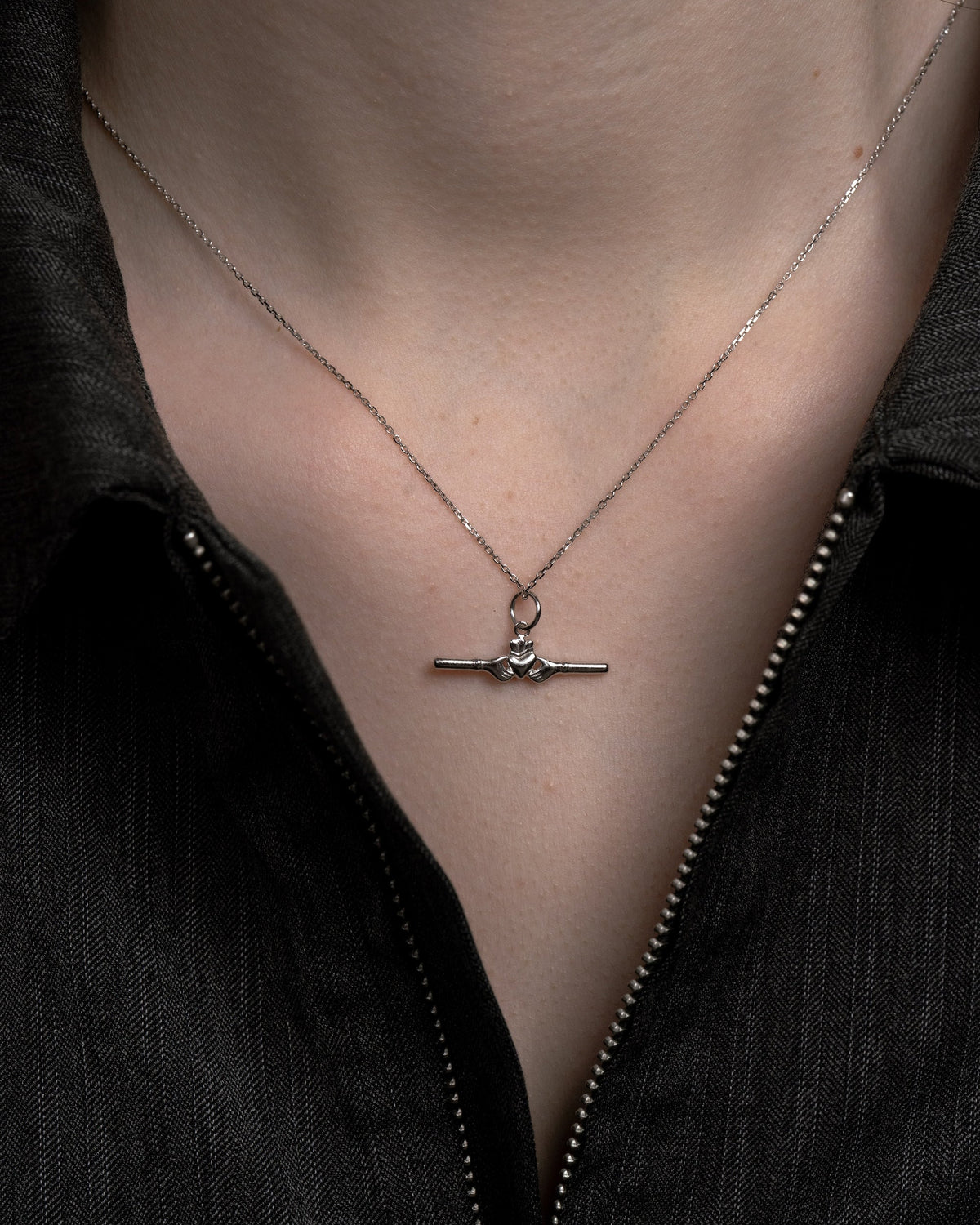 Delicate sterling silver chain with a small horizontal Claddagh bar pendant by Lines &amp; Current