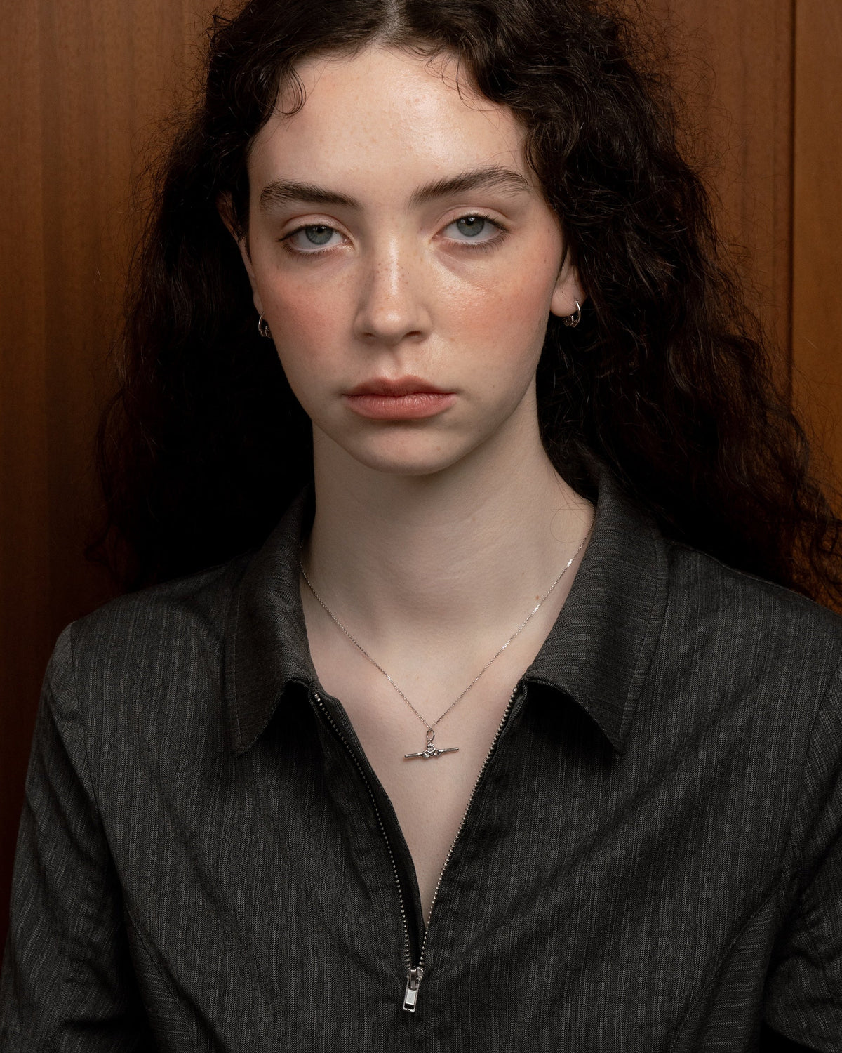 Close-up portrait wearing a sterling silver Claddagh bar necklace by Lines &amp; Current