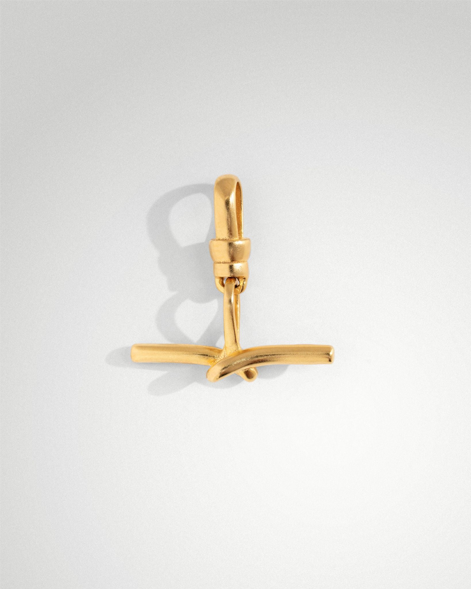 Tabitha T bar charm in unpolished rhodium-plated sterling silver, 20mm x 20mm, with overlapping detail and Albert style bail for chain attachment.